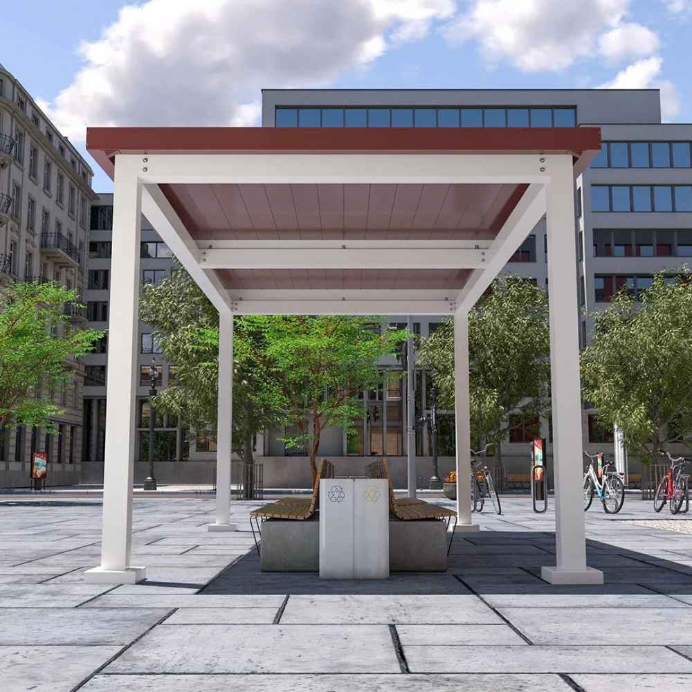 A white Structureworks Pavilion Trex Pergola with a red roof shades a round planter and bench setup in a city square