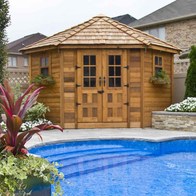A beautiful wooden Outdoor Living Today 9×9 Penthouse Garden Shed stands poolside