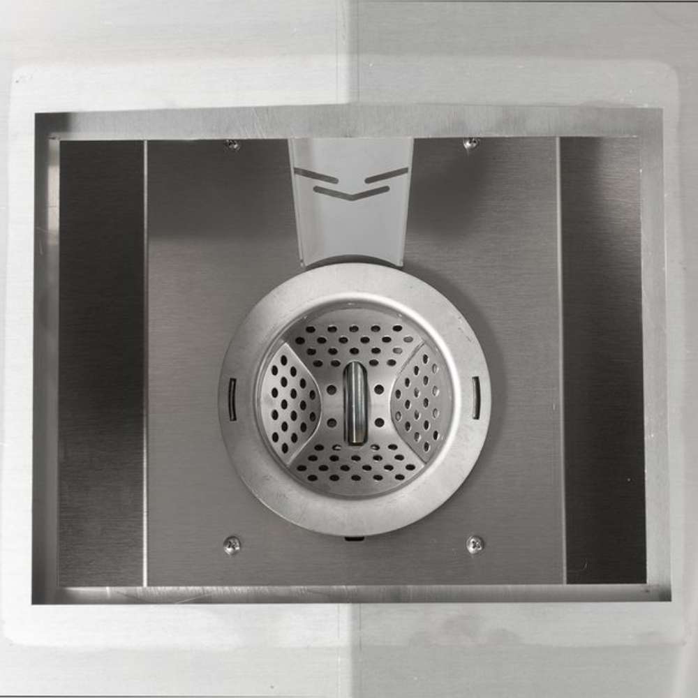 A close-up of the pellet burn pot inside the Memphis Grills Elite Cart ITC3 shows its well-ventilated stainless steel design for efficient wood pellet combustion