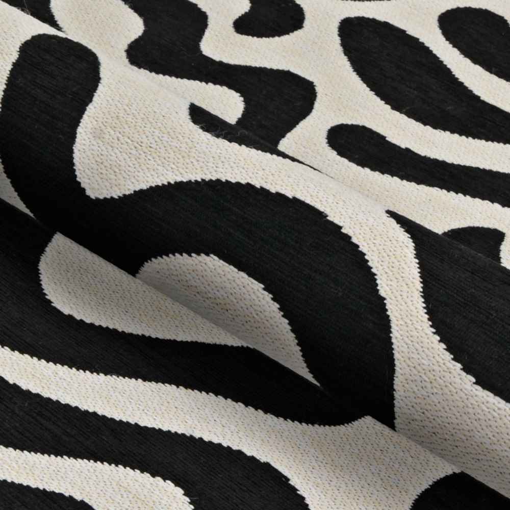 A detailed fabric view of the Couristan Castille Indoor/Outdoor Rug - Graffiti/Black-White reveals its woven texture and organic black-and-white swirl design