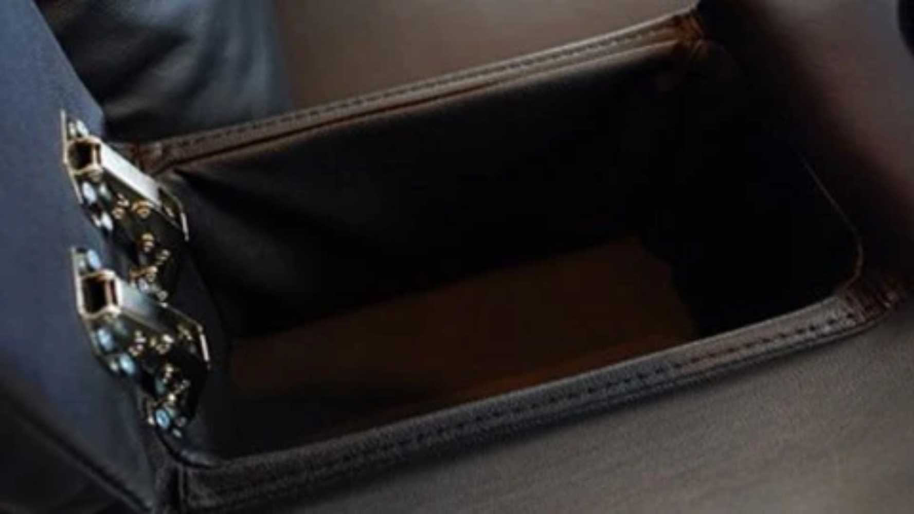 A hidden storage compartment inside the armrest of Valencia Olivia Home Theater Seating