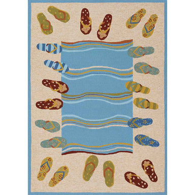 A rectangular version of the Couristan Covington Indoor/Outdoor Rug - Sandals/Sand-Multi shows a full beach towel-inspired pattern with flip-flops surrounding wavy water
