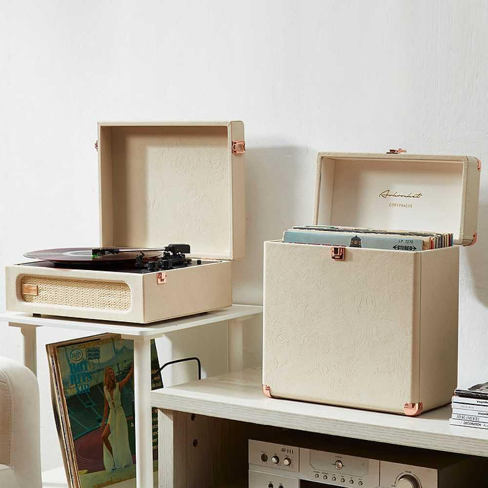 Arkrocket Coryphaeus Bluetooth Record Player with Record Storage Case (Flora Engraved) placed on a wooden stand