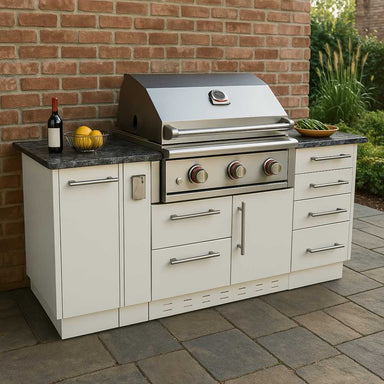 A sleek stainless steel Sunstone 5.5ft Outdoor Grill Island Package stands on a stone patio against a brick wall, with wine and lemons on the counter