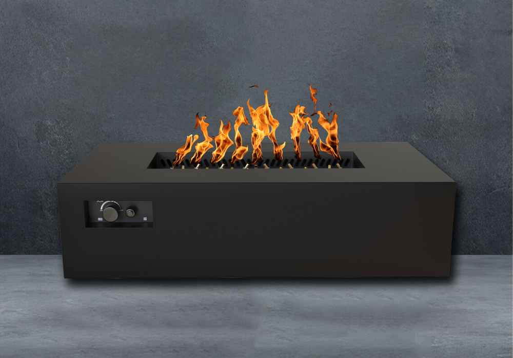 Black Warming Trends AON Steel Rectangular Fire Pit Table displays vivid flames rising from the burner against a dark stone background