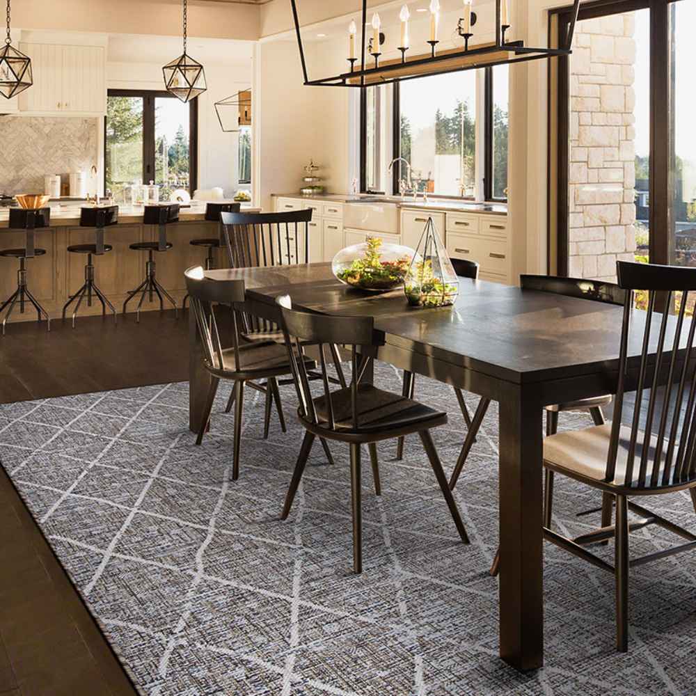 Couristan Charm Indoor/Outdoor Rug - Thicket/Twig is elegantly displayed in a bright, modern dining room