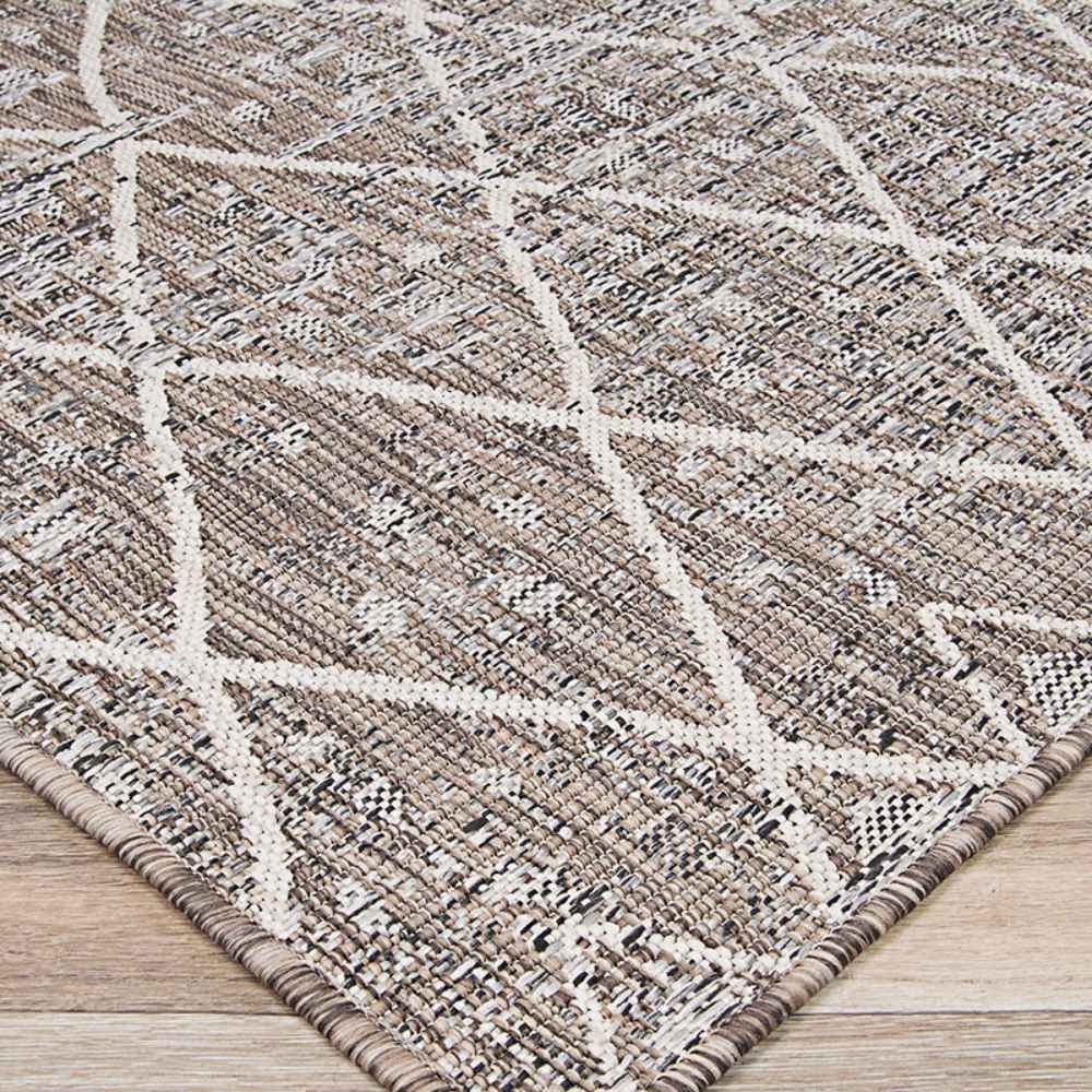 Couristan Charm Indoor/Outdoor Rug - Thicket/Twig is pictured from an angle to show its flatwoven structure and repeating geometric pattern