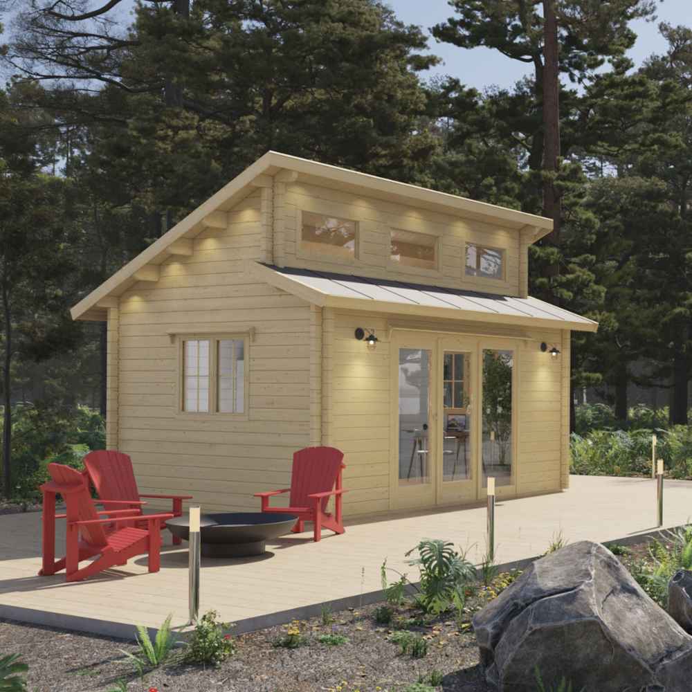 Evening lighting highlights the inviting front deck and tall gabled roof of the Sawmill Structures The Versa 160 Atrium 70MM Garden Room