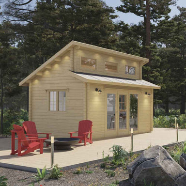 Evening lighting highlights the inviting front deck and tall gabled roof of the Sawmill Structures The Versa 160 Atrium 70MM Garden Room
