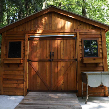 Outdoor Living Today 12×16 Double Door Space Master Storage Shed displays a classic front view with wide double doors and two square windows on each side for a balanced, rustic look
