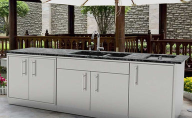 Sunstone 7ft Bar Center Outdoor Island Package installed outdoors on a patio under umbrellas, blending perfectly with a garden setting