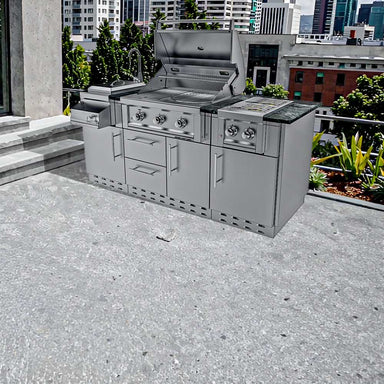 Sunstone Caprice 6ft 4in Outdoor Grill & Bar Sink Outdoor Island Package is shown fully assembled and placed on a modern rooftop patio with a city skyline in the background