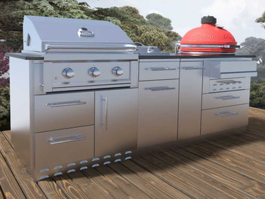 Sunstone Kamado 8ft Outdoor Grill & Cabinet Island Package is shown installed on a wooden deck with trees in the background, combining style and outdoor functionality