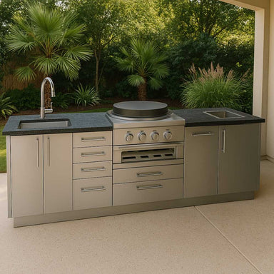 Sunstone Mongo 8ft Outdoor Grill & Cabinet Island Package showcases a round cooktop, dual sinks, and stainless cabinets in a tropical backyard setting