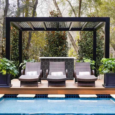 The patterned ceiling of a Structureworks Shadow Trex Pergola creates intricate light play beneath a clear blue sky and open air