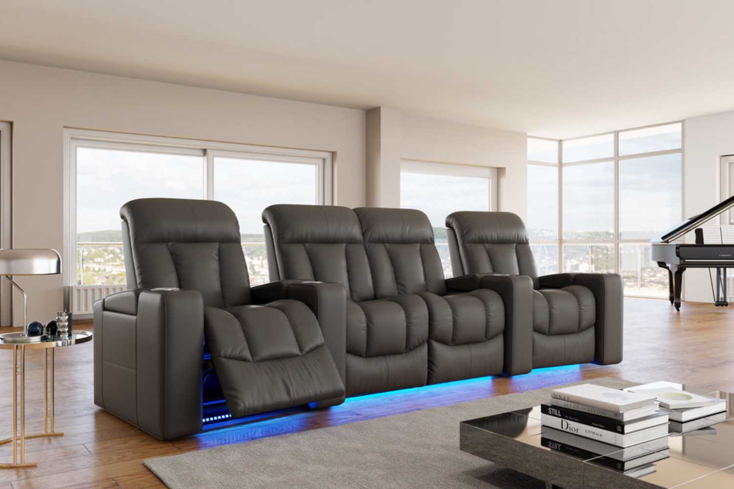 The image displays Valencia Olivia Home Theater Seating in a luxurious room setting, featuring four plush, black leather recliners with ambient blue LED lighting underneath