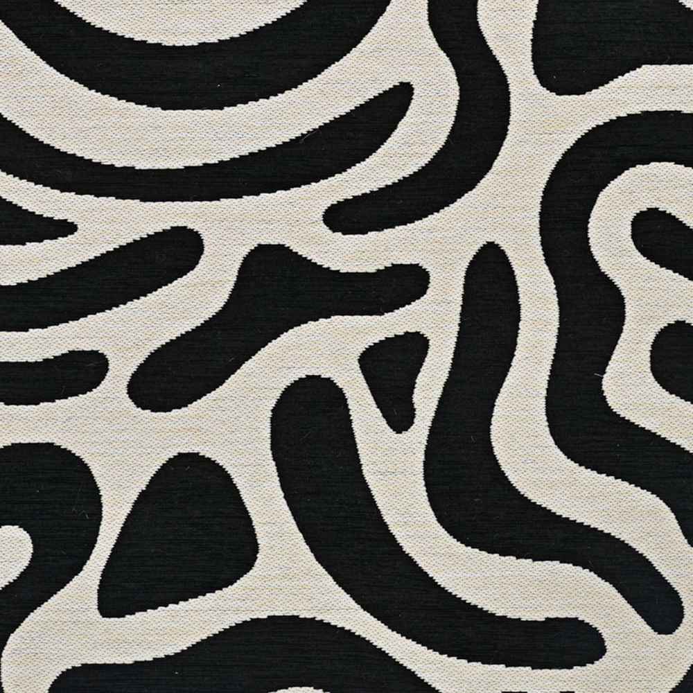 This detailed section of the Couristan Castille Indoor/Outdoor Rug - Graffiti/Black-White highlights its random, amoeba-like black shapes against a white background