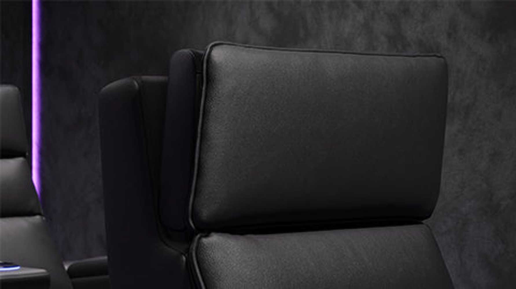 This image highlights the Valencia Monza Single Pillow Top Carbon Fiber Home Theater Seating's adjustable headrest