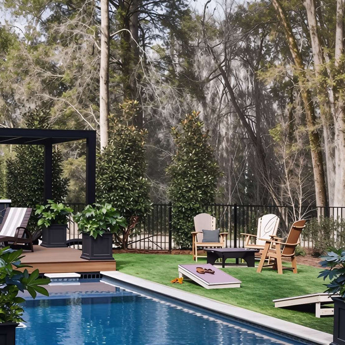 A sleek black pergola stands over a modern deck beside a pool, offering a clean visual for those comparing Wood vs. Aluminum Pergolas