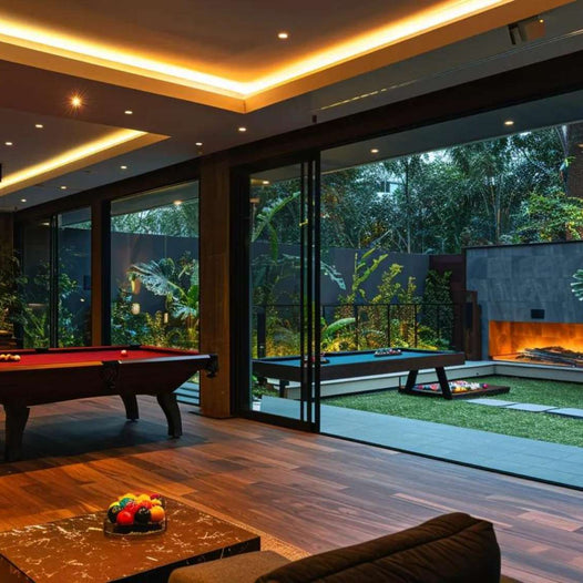 A sleek man cave with warm wood floors, a red billiard table, and sliding glass doors opening to a lush garden defines What is a Man Cave Room in style