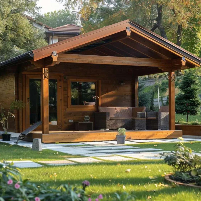 A small wooden garden retreat with wide windows and a shaded porch rests in a lush backyard, perfectly illustrating How Much Does a Garden House Cost in 2025