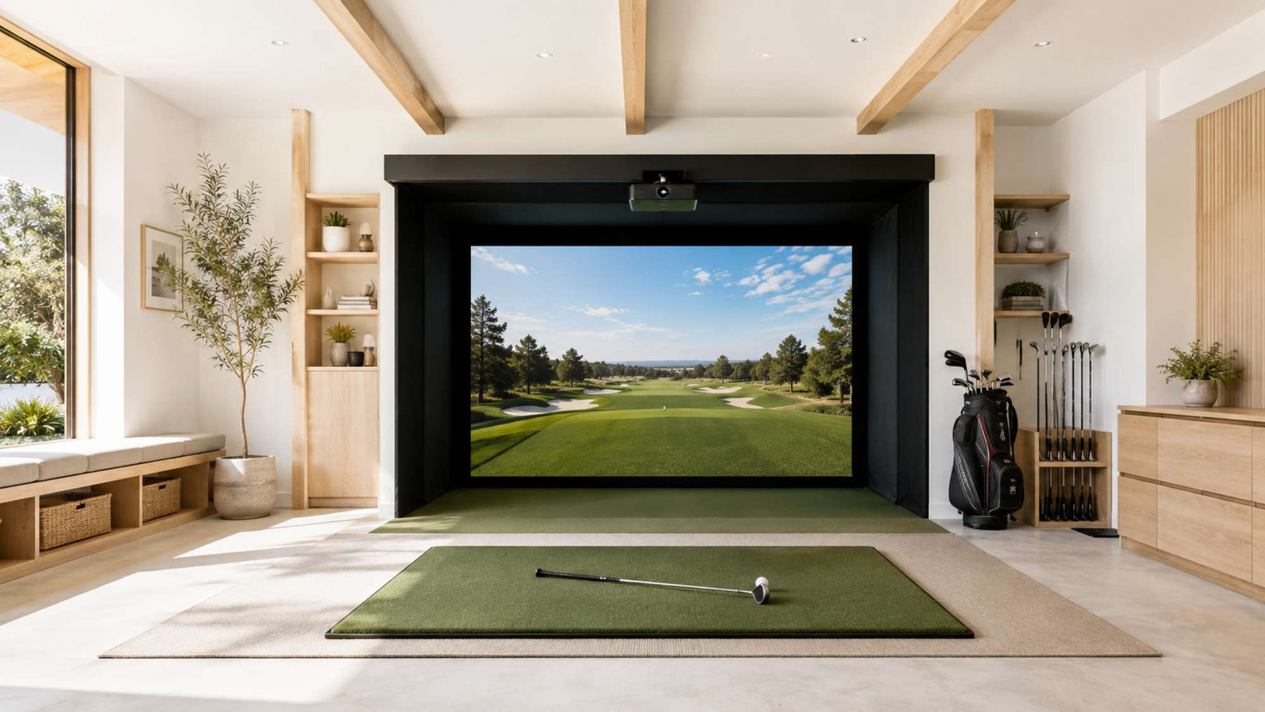 Bright home golf simulator room with a large golf course screen, green hitting mat, golf clubs, and light wood storage