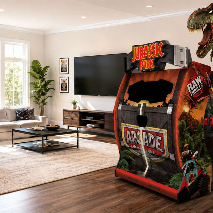 Bright modern game room featuring a Jurassic Park Arcade Machine beside a sofa, foosball table, TV, and large sunlit windows