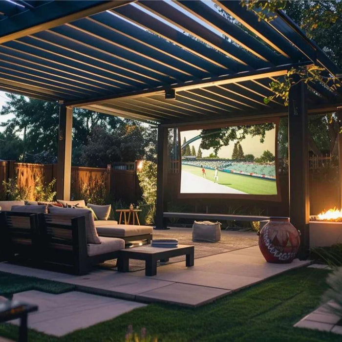 Cozy backyard pergola movie night rental setup with cushioned seating, soft lighting, and a large outdoor screen playing a film under the evening sky