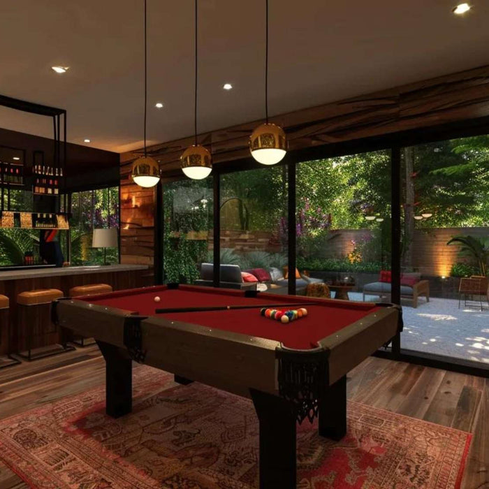 Luxury entertainment space with a pool table, bar seating, and large windows, showcasing the benefits of a game room furniture investment