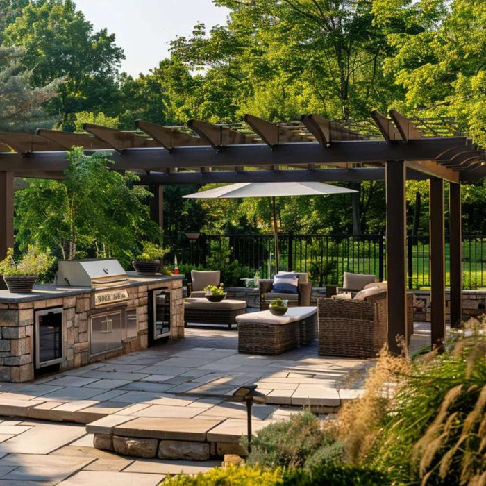 Luxury pergolas in austin, tx covering a backyard patio with outdoor kitchen, seating area, and trees creating a shaded outdoor living space