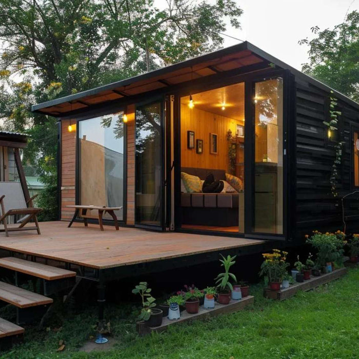 Modern backyard cabin with glass doors and deck, showing how a tiny home pay for itself through Airbnb rentals