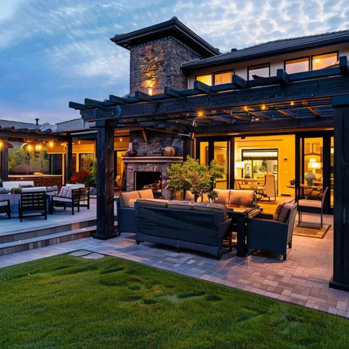 Modern backyard patio with a black pergola, outdoor seating, and warm lighting showcasing pergola curb appeal at dusk