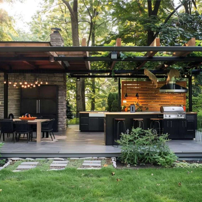 Modern covered outdoor kitchen and dining patio surrounded by trees and lawn, showing one stylish way to monetize backyard space