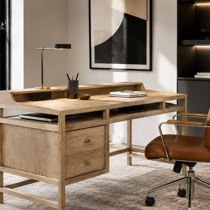 Modern home office with a light wood desk with outlets, built-in drawers, a leather chair, dark shelving, and large windows