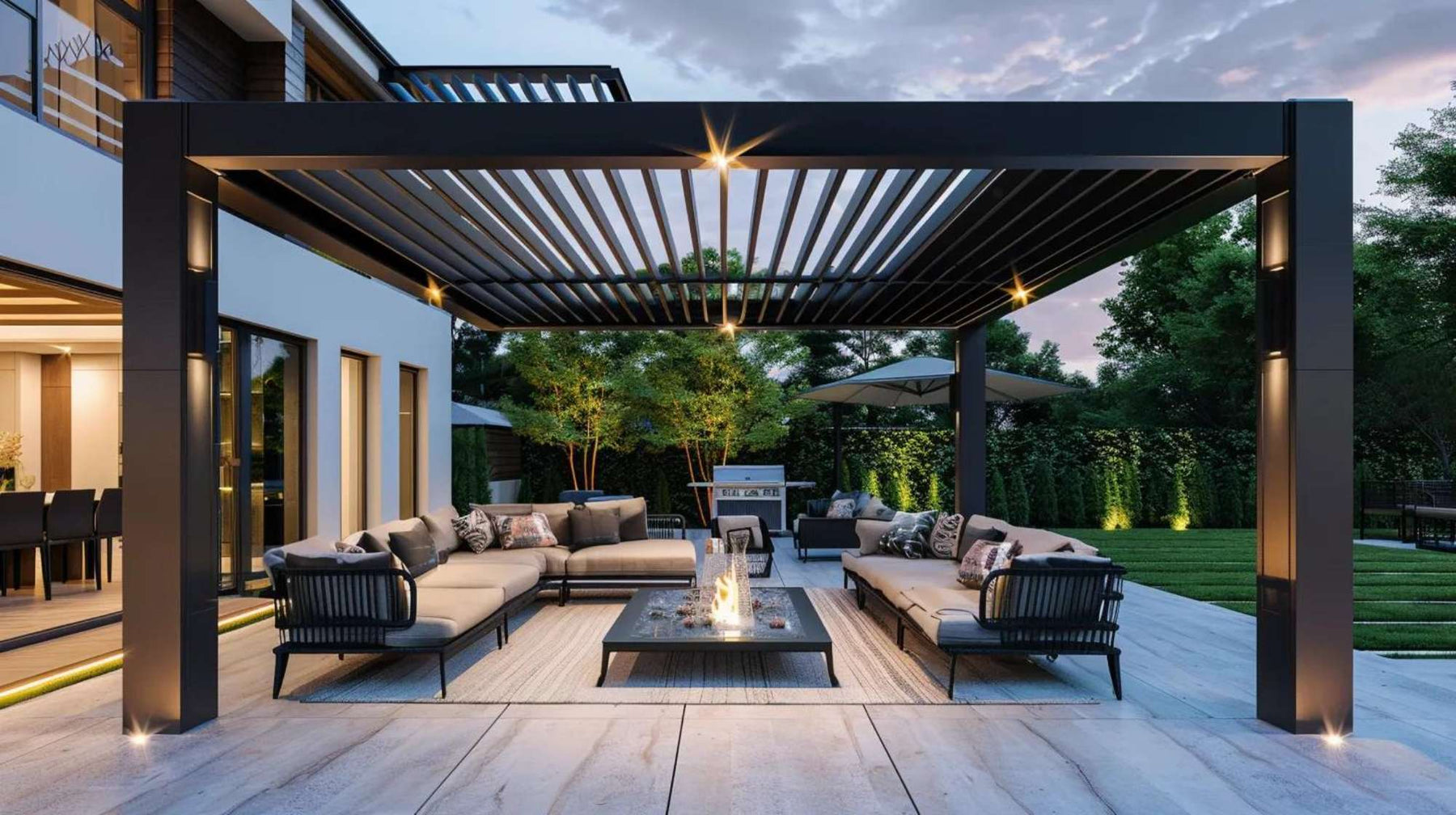 Modern outdoor living area with a black aluminum pergola over lounge seating and a fire table, highlighting the importance of pergola warranties