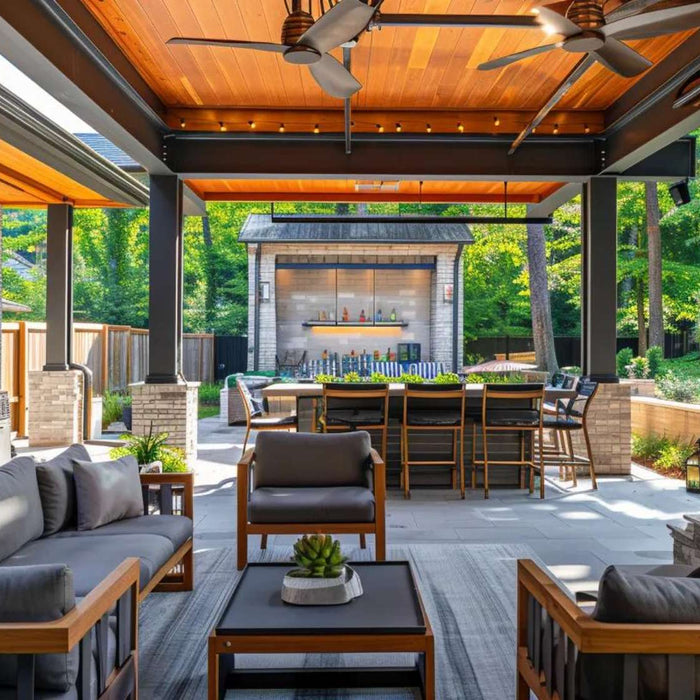 Modern outdoor living space with covered seating, outdoor kitchen, fireplace, and dining area for backyard entertaining
