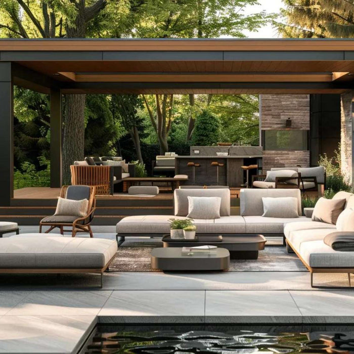 Modern patio with cushioned sofas under a covered pergola surrounded by greenery, emphasizing the need to maintain outdoor furniture for lasting comfort and style