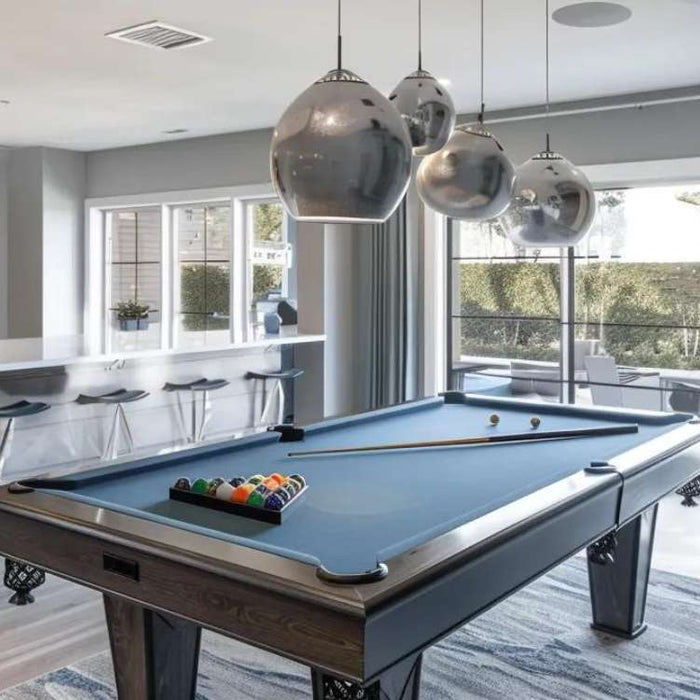 Modern pool table room with bar seating, pendant lights, and large glass doors, inspiring stylish small game room ideas