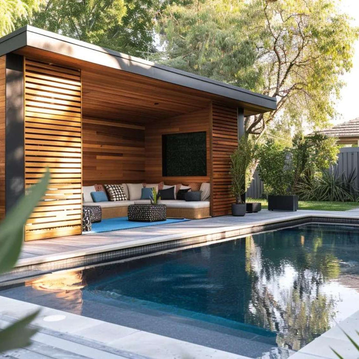 Modern poolside cabana with wood slat walls and lounge seating highlights outdoor storage sheds trends in a landscaped backyard