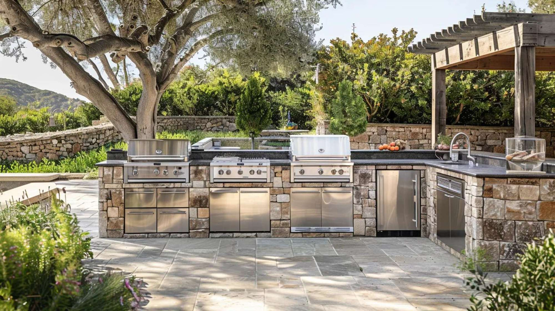 Outdoor kitchen safety starts with a stone outdoor kitchen featuring stainless steel grills, open workspace, and clear pathways