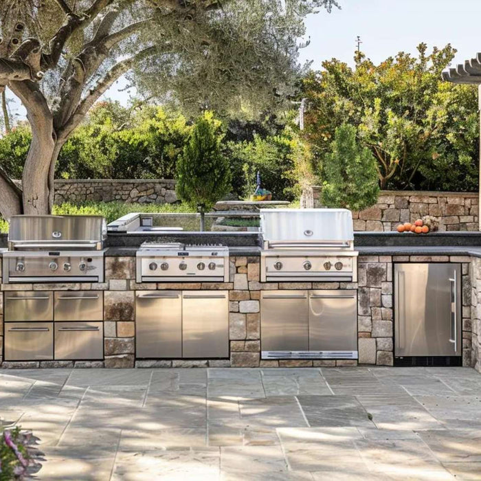 Outdoor kitchen safety starts with a stone outdoor kitchen featuring stainless steel grills, open workspace, and clear pathways
