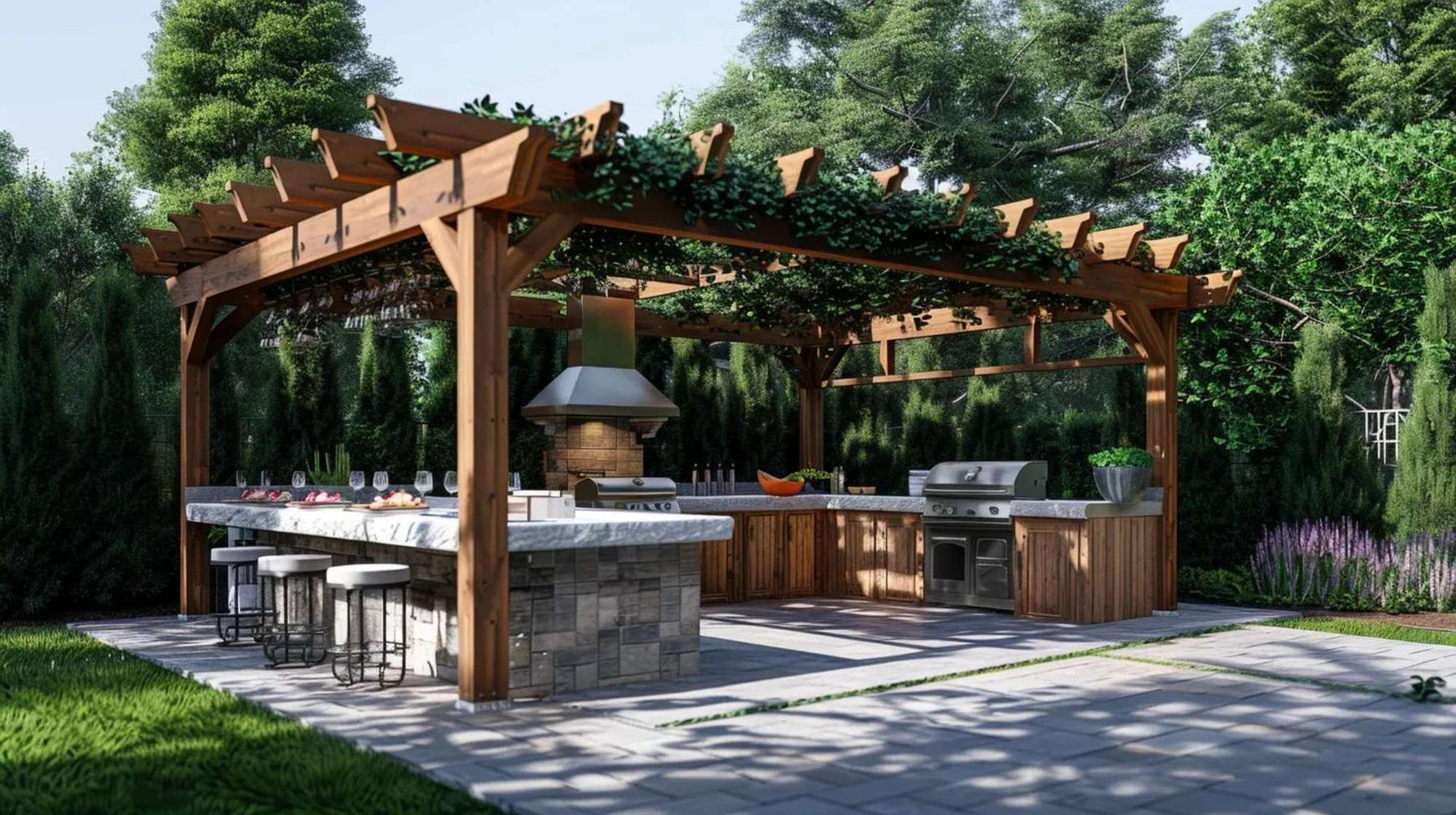 Outdoor kitchen setup beneath a wooden pergola featuring two built-in grills, a large stone island with bar seating, and surrounding greenery