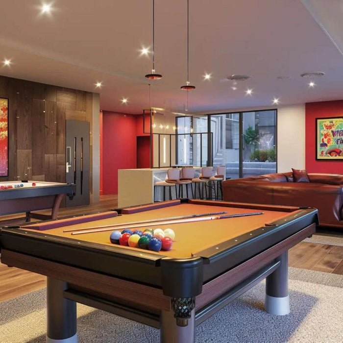 Stylish entertainment room with pool tables and seating highlighting how to soundproof a game room