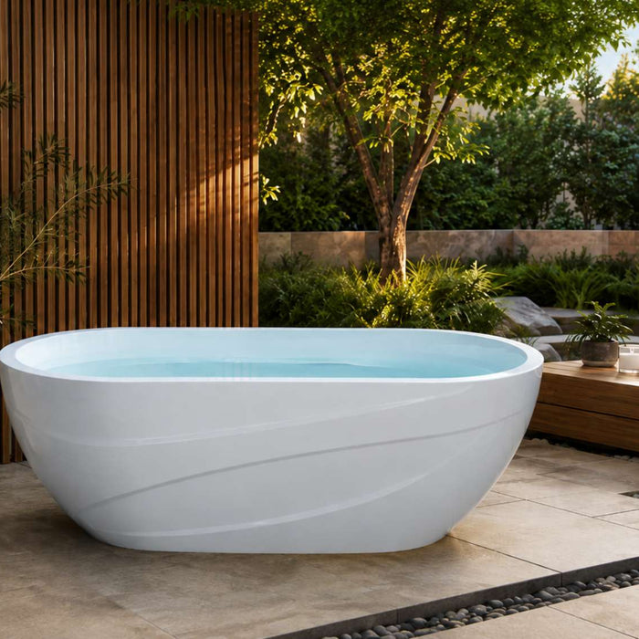 White home cold plunge tub filled with pale blue water on a modern outdoor patio with wood panels, greenery, and folded towels