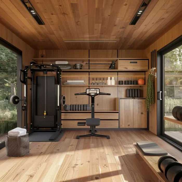 Wood-paneled tiny home gym with large windows, strength equipment, and natural light, designed for a backyard gym business