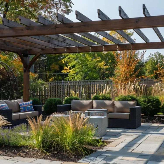 Wooden pergola with slatted beams over an outdoor seating area and stone patio, illustrating how to build wooden pergola for simple backyard shade