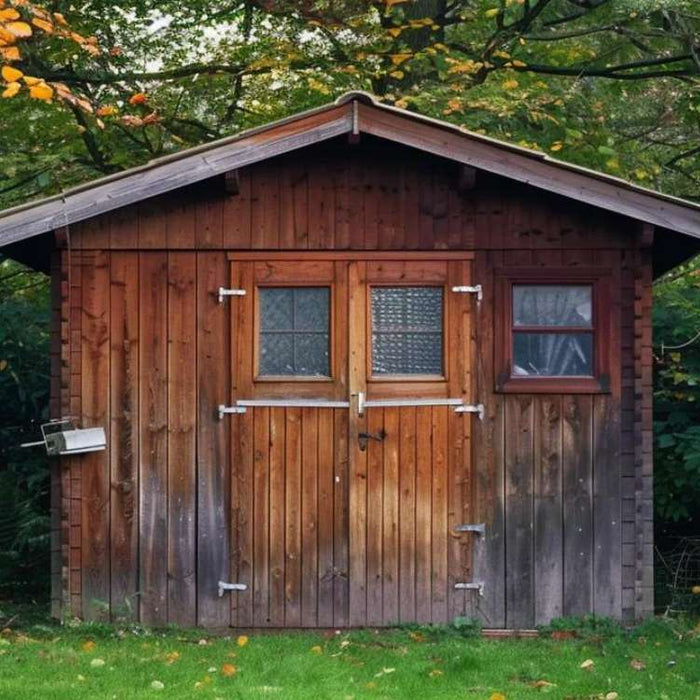 Wooden shed surrounded by trees sits on grass, raising the question are sheds considered permanent structures when placed long term