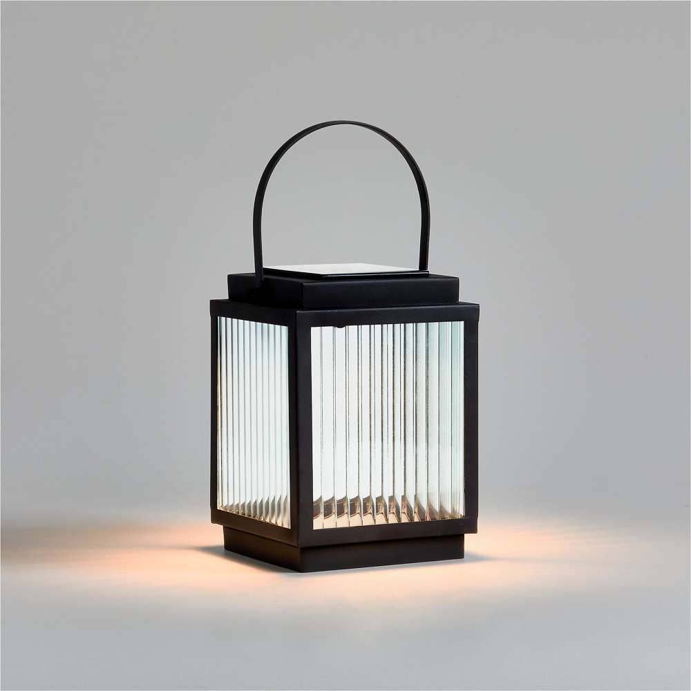 13 inch Crate & Barrel Alfresco Black Metal and Glass LED Solar Outdoor Lantern in matte black powdercoated steel with reeded glass panels
