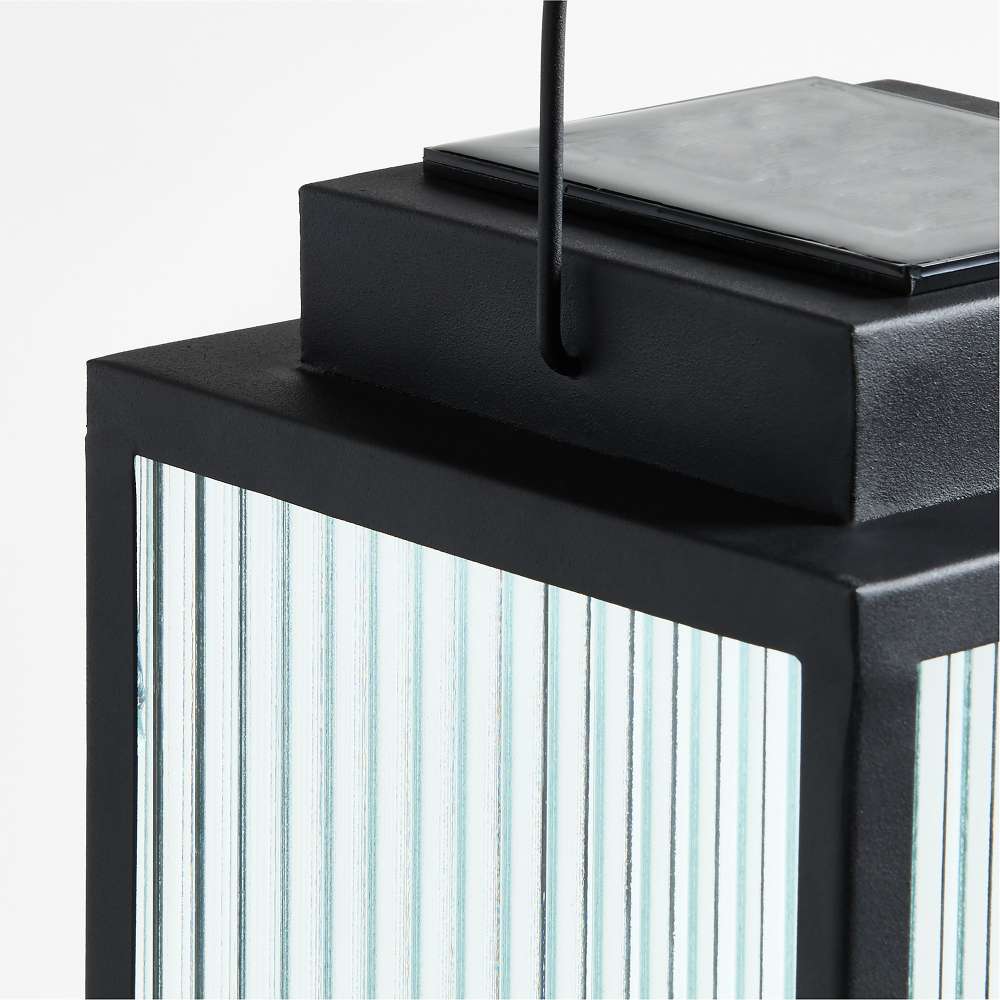 19 inch Crate & Barrel Alfresco Black Metal and Glass LED Solar Outdoor Lantern in an alternate view showing the removable solar panel on top