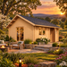 Small wood cabin with a gabled roof and glass doors, set on a stone patio with a fire pit at sunset.